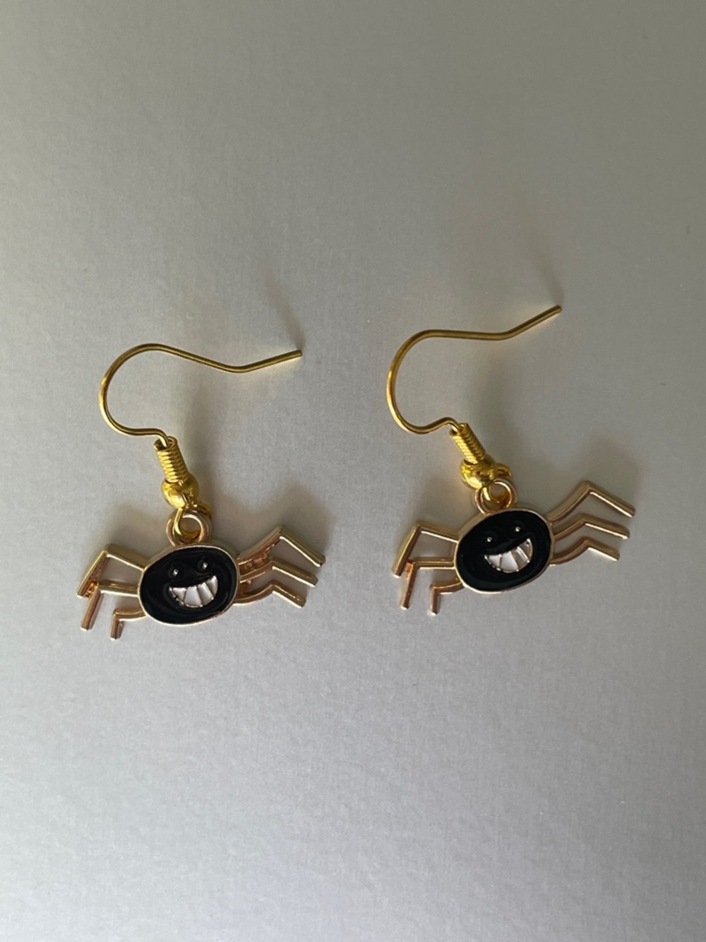 Gold Spider Dangle Earrings with Black Enamel Face